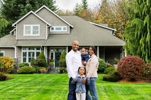 family sitting outside of their home